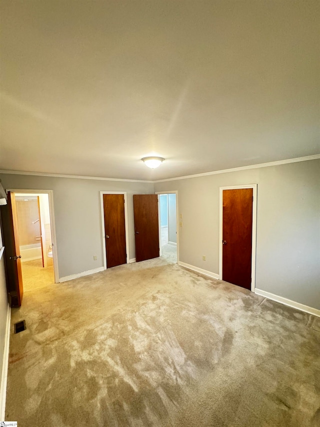 carpeted empty room featuring ornamental molding