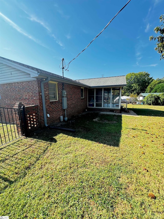 back of property featuring a lawn