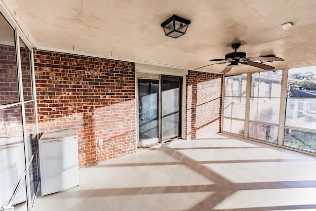 unfurnished sunroom with ceiling fan and a healthy amount of sunlight