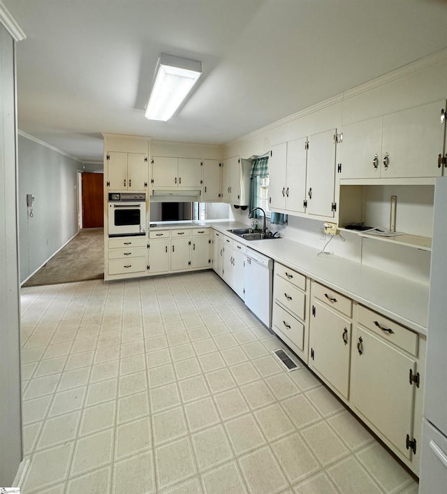 kitchen with ornamental molding, sink, and white appliances