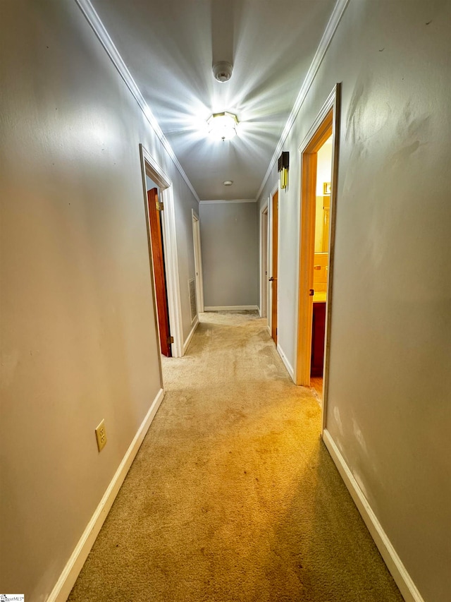 corridor featuring ornamental molding and light carpet