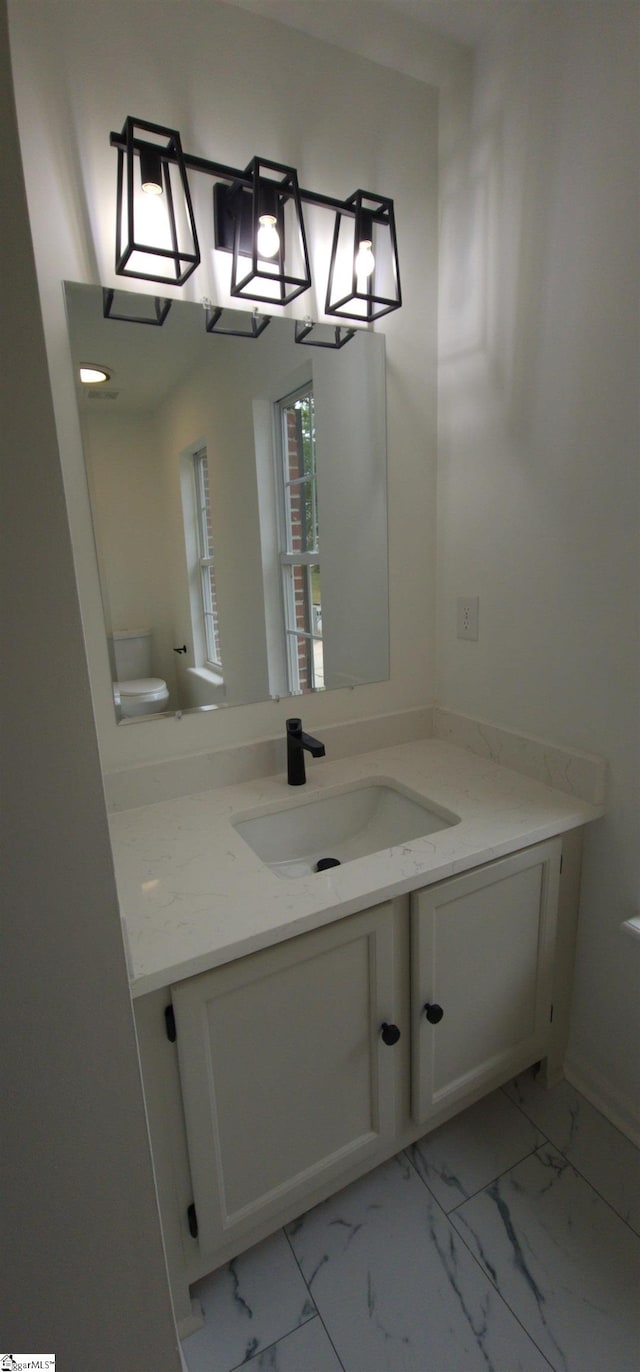 bathroom with vanity and toilet