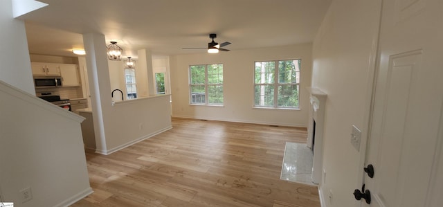 316 Windy Meadow Way, Simpsonville, SC 29680 - unfurnished living room featuring a sink, ceiling fan, light wood-type flooring, and baseboards