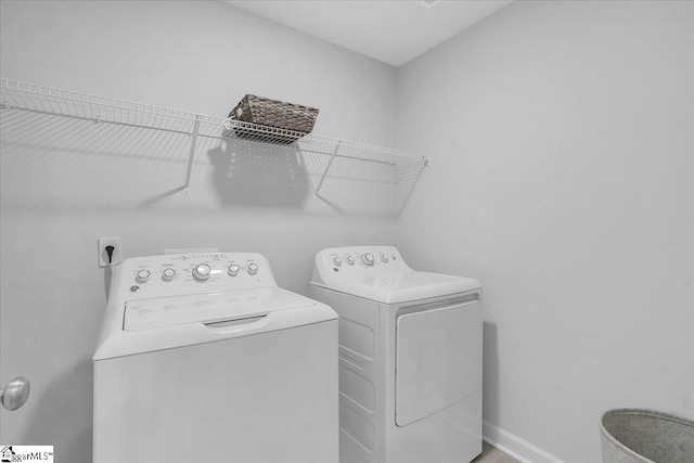 clothes washing area featuring independent washer and dryer