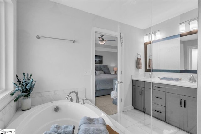 bathroom featuring a tub to relax in, vanity, and ceiling fan