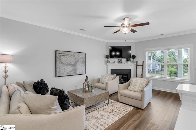 living room with ceiling fan, dark wood-type flooring, and crown molding