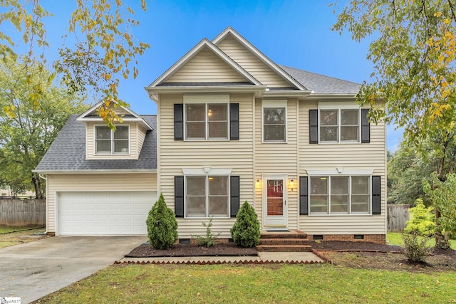 view of front of house featuring a front yard and a garage