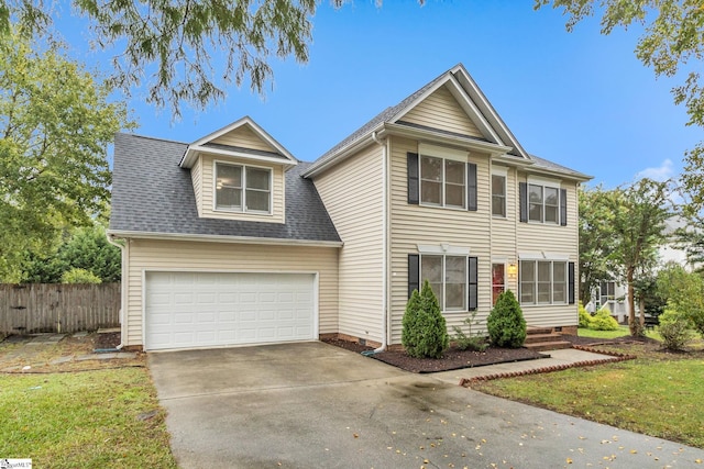 view of front of home featuring a garage and a front lawn