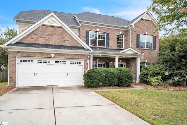 craftsman-style home with a front yard and a garage