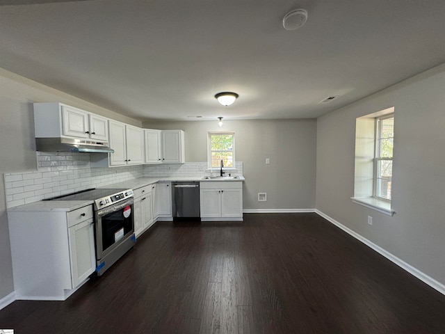 kitchen with dark hardwood / wood-style floors, sink, stainless steel appliances, and white cabinets