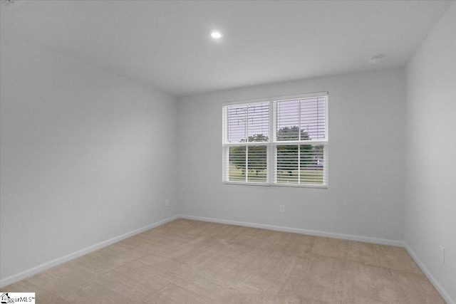 unfurnished room with light colored carpet