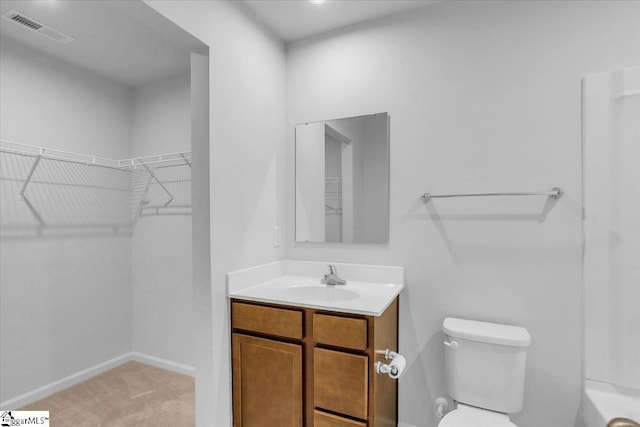 bathroom featuring vanity and toilet