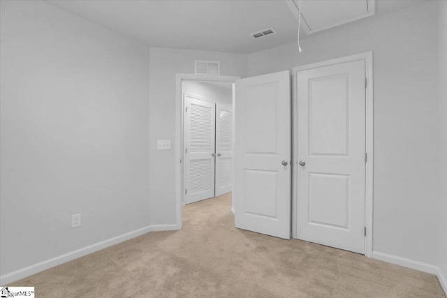 unfurnished bedroom featuring light carpet