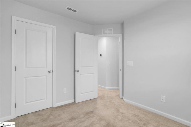 unfurnished bedroom with light colored carpet