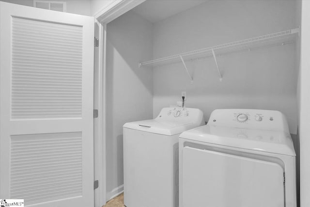 clothes washing area with washer and clothes dryer