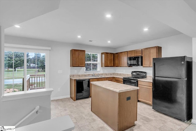 kitchen with a center island, sink, plenty of natural light, and black appliances