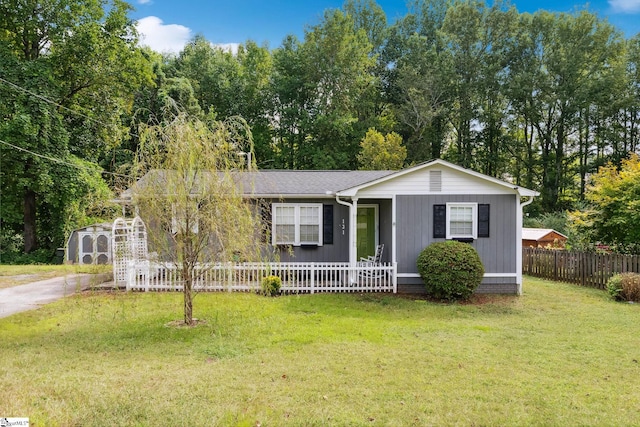 ranch-style home with a shed and a front yard