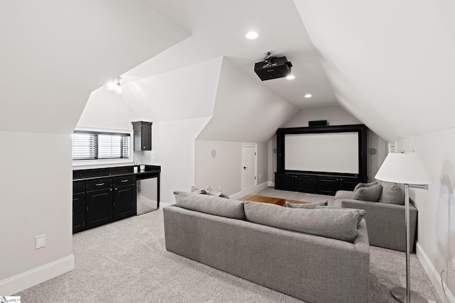 home theater featuring lofted ceiling and light carpet