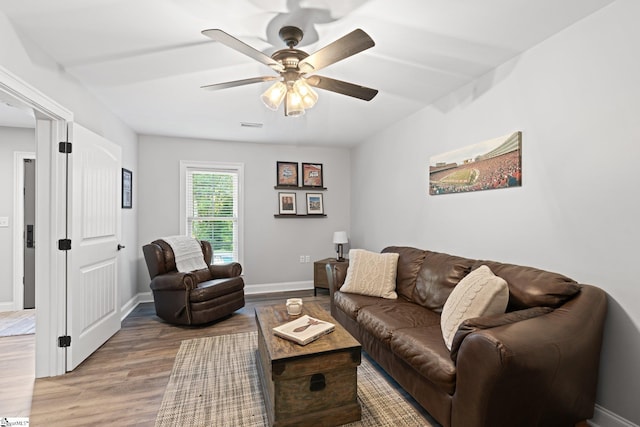 living room with ceiling fan and hardwood / wood-style floors