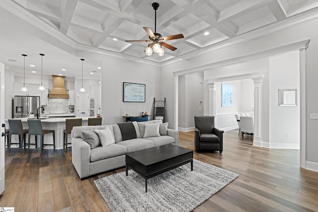 living room with ceiling fan, dark hardwood / wood-style floors, and ornamental molding