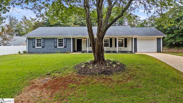 ranch-style home featuring a garage and a front yard