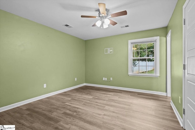 spare room featuring light wood-type flooring and ceiling fan