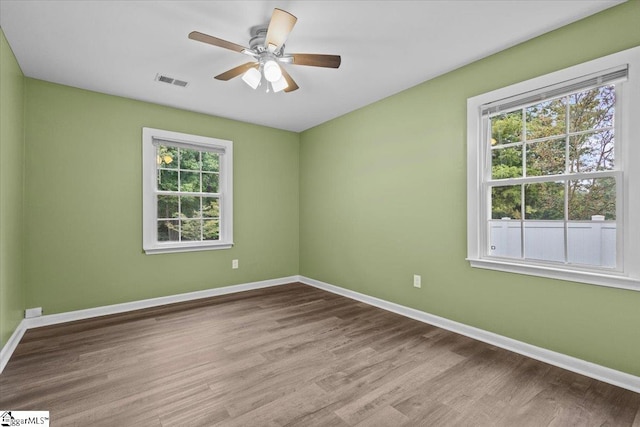 spare room featuring ceiling fan, plenty of natural light, and light hardwood / wood-style floors