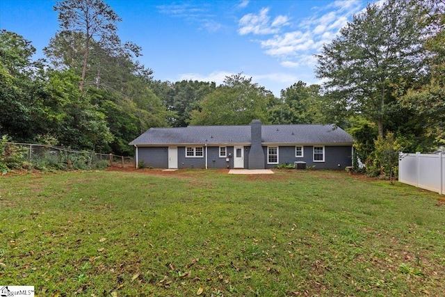 view of front of home featuring a patio, central AC, and a front yard