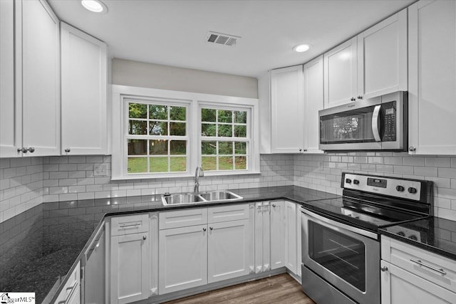 kitchen with white cabinetry, sink, and stainless steel appliances