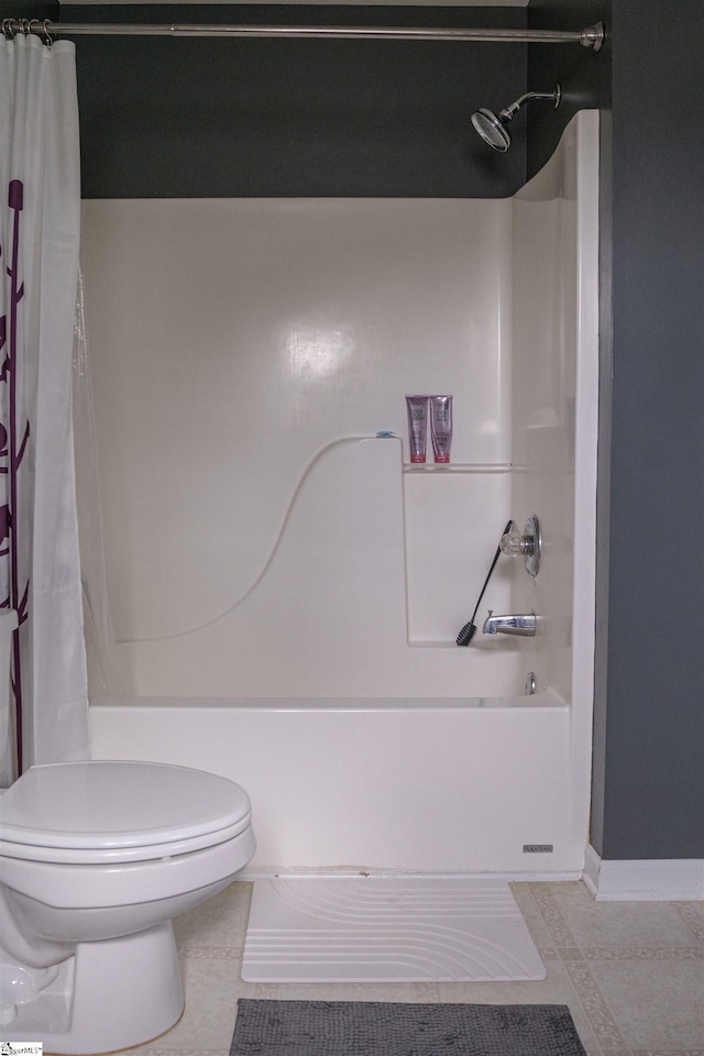 bathroom featuring shower / tub combo with curtain, tile patterned floors, and toilet