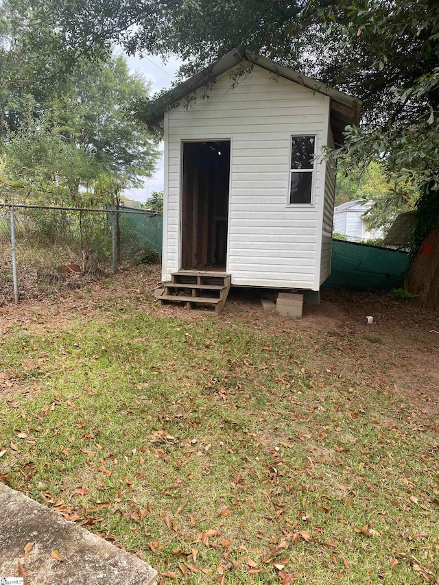 view of outbuilding with a yard