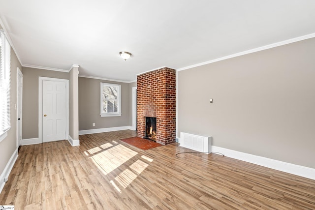 unfurnished living room with visible vents, baseboards, light wood-style flooring, ornamental molding, and a fireplace