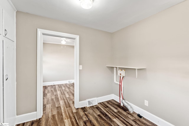 clothes washing area with dark wood-style floors, laundry area, visible vents, and baseboards