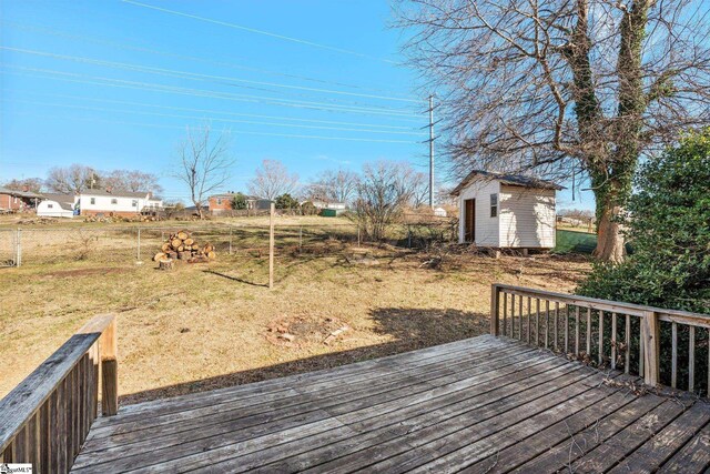 deck with a storage shed and an outbuilding