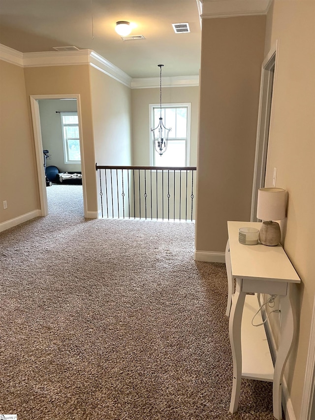 carpeted empty room with an inviting chandelier and crown molding