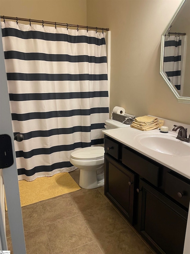 bathroom featuring tile patterned floors, vanity, and toilet