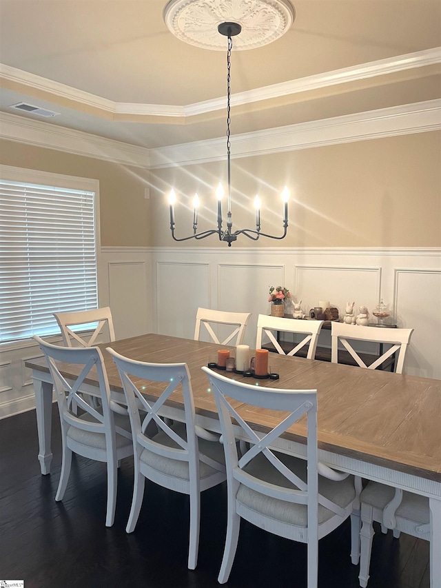 dining space with ornamental molding, a chandelier, and dark hardwood / wood-style flooring