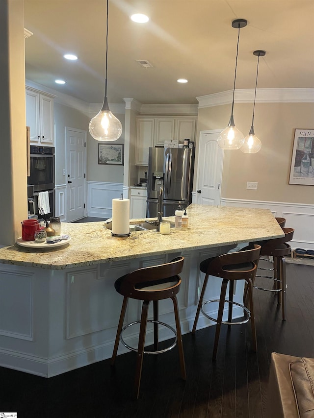 kitchen featuring white cabinets, dark hardwood / wood-style floors, hanging light fixtures, and stainless steel fridge with ice dispenser