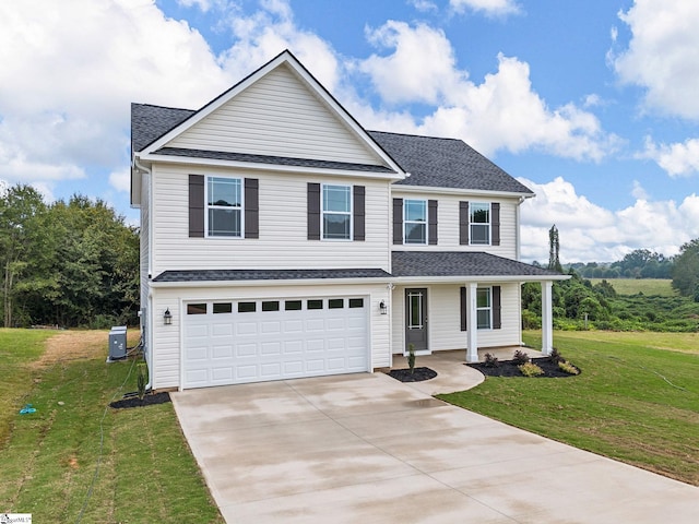 view of front of house featuring cooling unit, a front lawn, and a garage