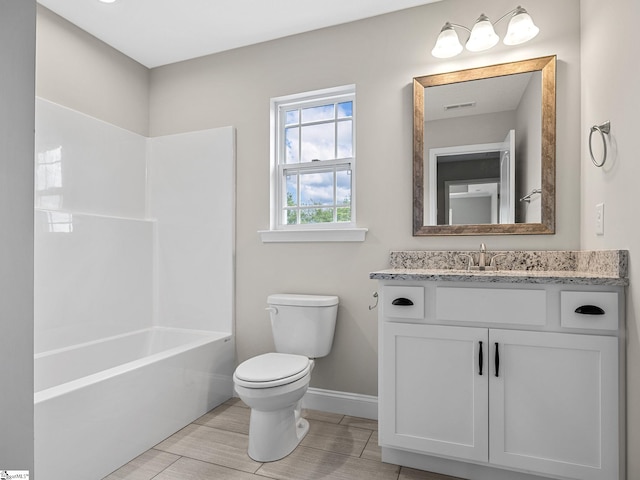 full bathroom featuring vanity, bathing tub / shower combination, and toilet