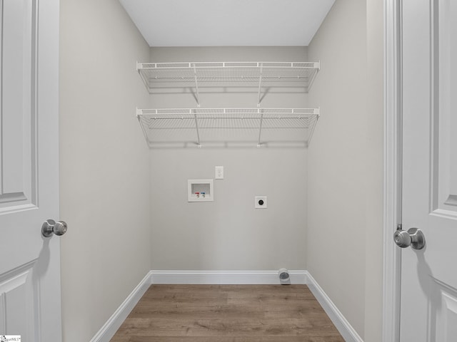 washroom featuring washer hookup, light wood-type flooring, and electric dryer hookup