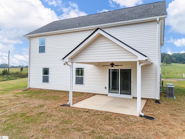 back of house featuring a lawn, ceiling fan, central AC unit, and a patio area