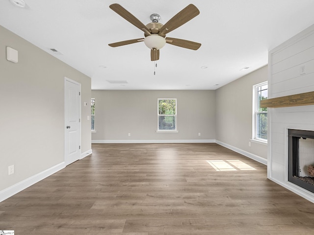 unfurnished living room with ceiling fan and wood-type flooring