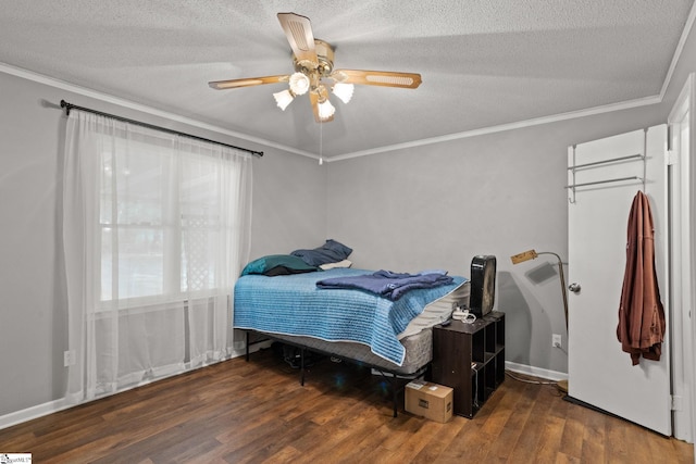 bedroom with ceiling fan, a textured ceiling, and dark wood-type flooring