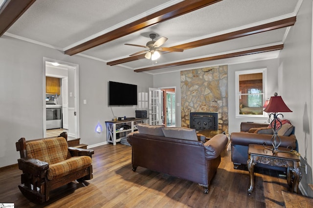 living room featuring a textured ceiling, a stone fireplace, hardwood / wood-style floors, and ceiling fan