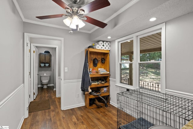 interior space featuring ornamental molding, a textured ceiling, ceiling fan, and dark hardwood / wood-style flooring