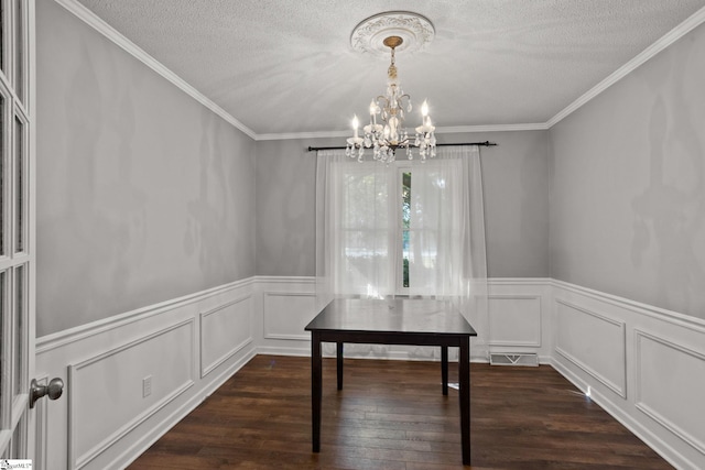 unfurnished dining area with a notable chandelier, crown molding, and dark wood-type flooring