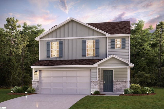 view of front of home with a yard and a garage