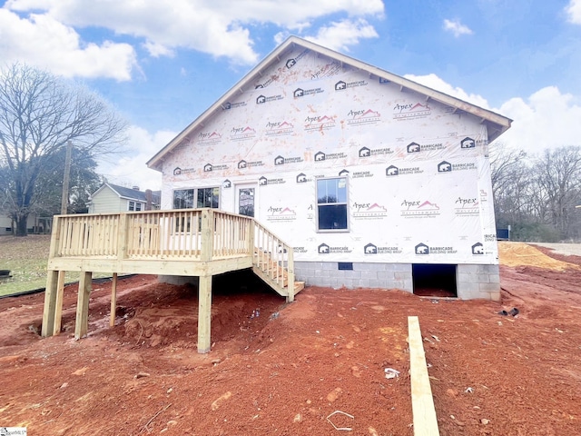 rear view of house with a wooden deck