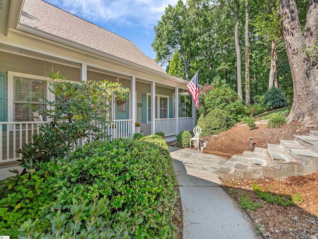 view of exterior entry featuring a porch